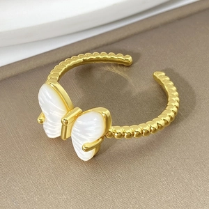 Macro shot of 18K gold plated butterfly ring with white mother-of-pearl wings