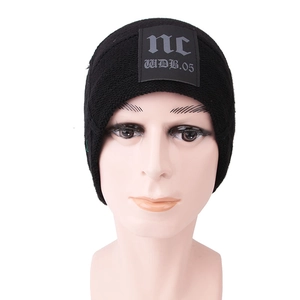 Close-up of black knitted beanie featuring a square streetwear patch with nc logo