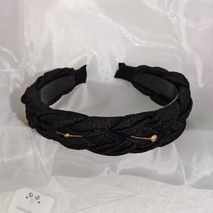 Detail of black woven headband featuring delicate gold chains and small round beads