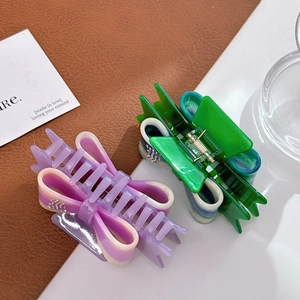 Bow-shaped acetate hair claws with rhinestones in purple pink and green blue gradients