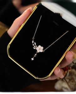 Detailed view of s925 silver necklace with mother of pearl flower and sparkling zircons