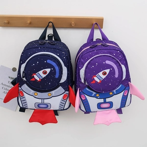 Detail view of rocket themed toddler safety backpacks in blue and purple with space wings