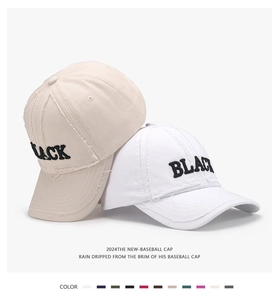 Close-up of distressed baseball caps with BLACK embroidery in beige and white colors