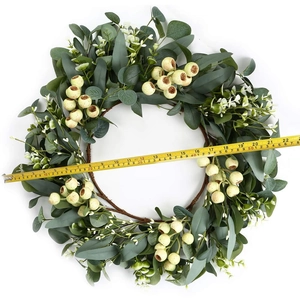 Artificial eucalyptus wreath with green leaves and berries, measuring 20 inches wide