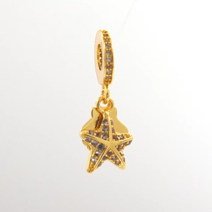 Detailed view of a golden starfish pendant inlaid with dark blue and purple zircons