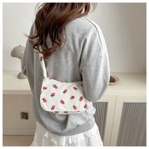 White corduroy strawberry print underarm bag with drawstring design and spacious interior