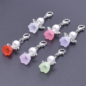 Detailed view of 6 colorful angel wing charms with lobster clasps for wedding party favors