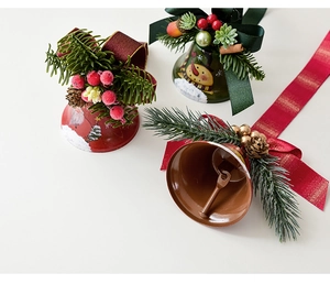 Detailed view of Christmas bells with pine needles, cones, berries and festive patterns
