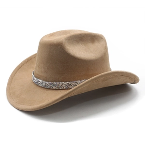 Detail of camel suede cowboy hat featuring a sparkling rhinestone band and wide brim