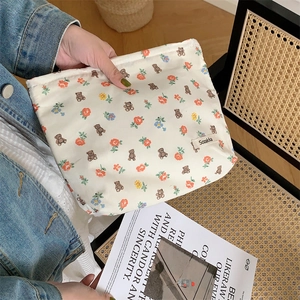 Floral cotton pouch with bear patterns shown held against a stylish lifestyle backdrop