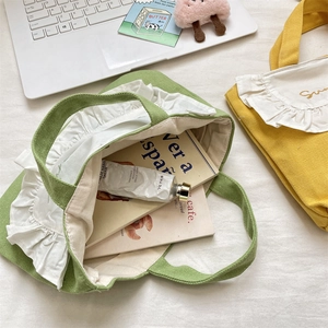 Detail of ruffled canvas lunch bags showing internal capacity for daily items