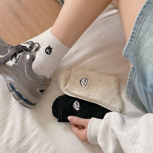 Cute embroidered cat socks in cream white and black, featuring colorful flecked knit texture