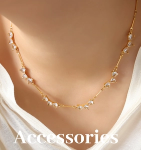 Detailed close-up of golden necklace featuring elegant heart-shaped zircon crystal inserts