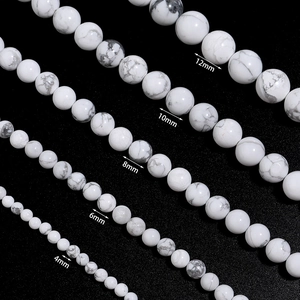 Macro shot of white howlite stone beads showing marble texture in 4mm to 12mm sizes