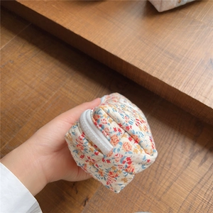 Macro view of floral quilted cotton pouch with texture and vintage floral pattern