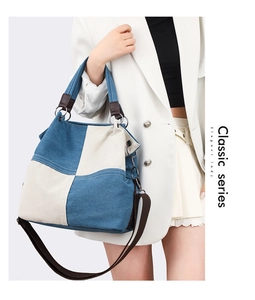 Close-up of blue and white canvas tote bag with brown straps and metal D-ring details