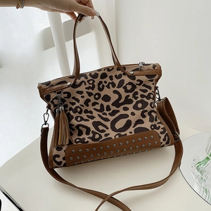 Brown leopard print canvas tote bag with leather trim and tassel accent
