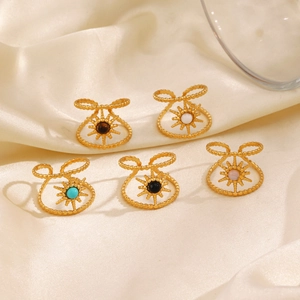 French vintage sunburst gold plated rings with natural stone inlays on silk fabric