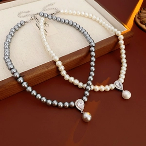 Elegant pearl necklaces with teardrop zircon pendants in white and grey colors
