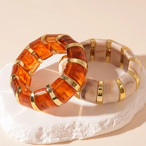 Vintage acrylic stretch bracelets in amber and cream resin with gold accents on stone