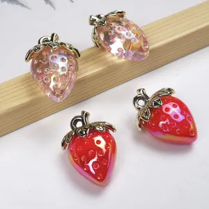 Macro shot of realistic acrylic strawberry pendants with iridescent and gradient finish