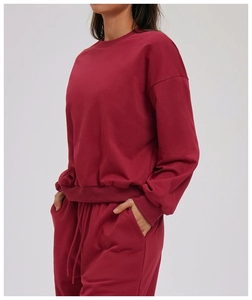 Detail view of burgundy round neck sweatshirt and matching drawstring joggers set