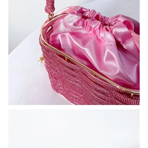 Close-up of pink luxury evening bucket bag with sparkling rhinestones and satin lining