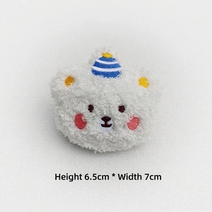 Close-up of plush cartoon bear brooch with dimensions 6.5cm height and 7cm width