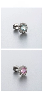 Detailed macro view of light blue and pink zircon titanium steel screw-back stud earrings