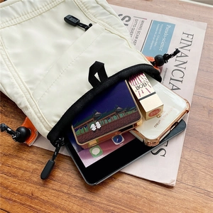 White nylon messenger bag with black drawstring showing spacious interior for tablet and cosmetics