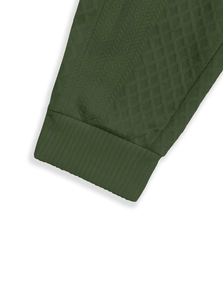 Detail of olive green tracksuit featuring jacquard texture and elastic ribbed cuffs