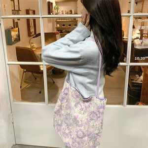 Detail of purple lace floral tote bag with 3D embroidery and slim shoulder strap