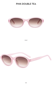 Detail view of pink oval frame sunglasses with gradient brown lenses and temple specs