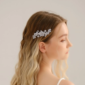 Detail view of a silver floral bridal hair comb with sparkling crystals on hair