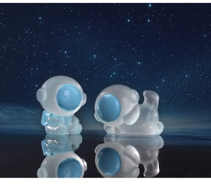 Luminous resin astronaut figurines reflecting on water with a starry sky background