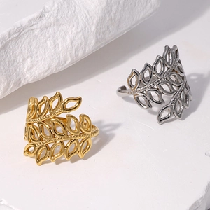 Detail of adjustable hollow leaf rings in gold and silver finish with metal texture