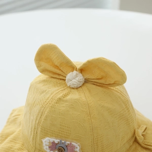 Yellow baby sun hat with cute rabbit ears and plush pom-pom decoration in soft cotton