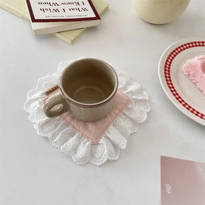 Detailed close-up of a pink floral lace coaster with scalloped edges for home decor