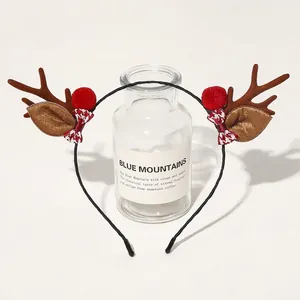 Detailed Christmas headband featuring plush brown reindeer antlers and red plaid bows