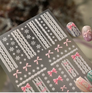 Close-up of 3D embossed sweater texture nail stickers with pink bows and snowflakes