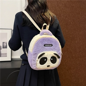 Detail view of a cute plush panda backpack in lavender and white on a model's back