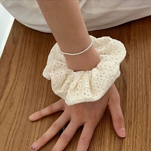 Minimalist 925 sterling silver bead bracelet with white lace scrunchie on wood surface