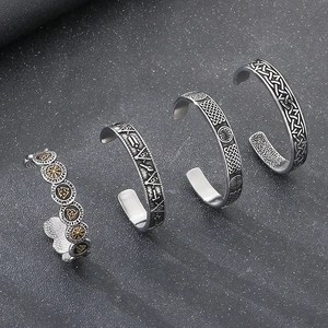 Vintage Nordic Viking stainless steel open bangles with Odin's shield and runes on black background