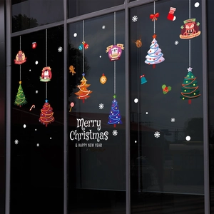 Christmas tree window stickers with reindeer and penguins on a glass storefront