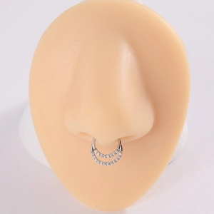 Close-up of silver G23 titanium septum ring with double-row zircon on nose model