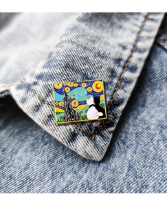 Detail of Van Gogh Starry Night enamel pin with cats pinned on a denim jacket collar