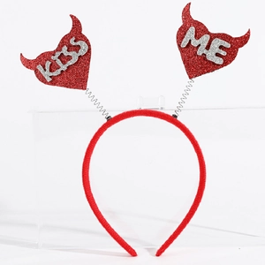 Close-up of red plush headband with spring hearts featuring silver glitter KISS ME text