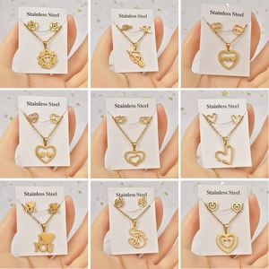 Nine-grid display of titanium steel heart and flower necklace sets on white cards