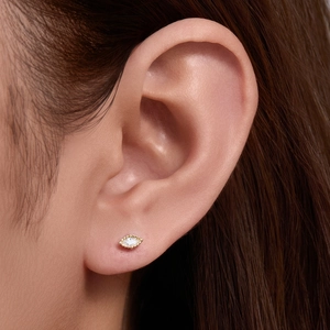 Minimalist marquise cut diamond stud earring in gold finish worn on earlobe