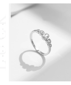 Macro detail of S925 sterling silver ring with five bezel-set sparkling oval crystals